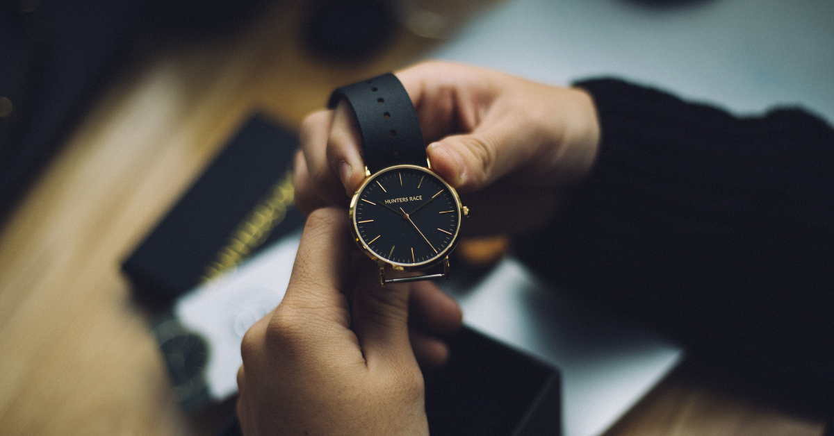 Man holding watch thinking about intraday liquidity